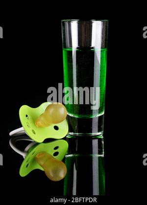 Baby dummy with alcoholic beverage isolated on black Stock Photo