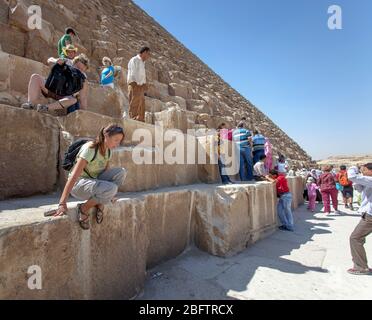 Tourists Climbing on The Great Pyramid of Giza. Stock Photo