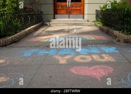 New York, NY, USA. April 19, 2020. Thank You messages of support written in chalk on the sidewalk outside of an apartment building on the Upper West S Stock Photo