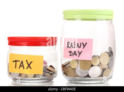 Glass banks for tips with money isolated on white Stock Photo