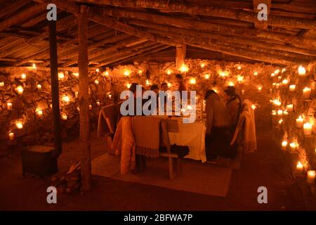 A gourmet dinner for guests of Aman Gangtey, in a candlelit potato shed, Bhutan. Stock Photo