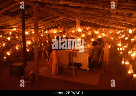 A gourmet dinner for guests of Aman Gangtey, in a candlelit potato shed, Bhutan. Stock Photo