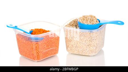 Measuring spoons and plastic containers with grain isolated on white Stock Photo