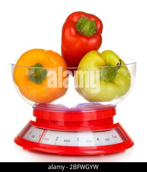 fresh colorful peppers in a kitchen scales isolated on white Stock Photo