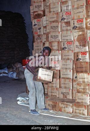 1993 - A Somali man works in a food storage warehouse in Kismayo.  The supplies are deliverd to food distribution centers by a Belgian contingent that is in Somalia in support of Operation CONTINUE HOPE.