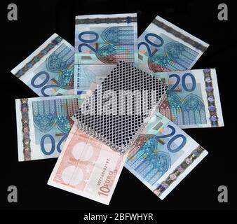 Euro and a deck of playing cards isolated on black Stock Photo