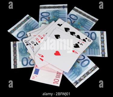 Euro and a deck of playing cards isolated on black Stock Photo