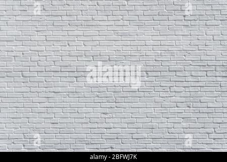 Brick painted white wall with delicate shadows, can be used for texture or background Stock Photo