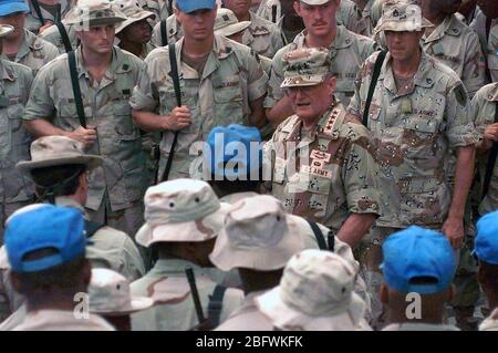 US Army GEN John Shalikashvili, Chairman, Joint Chiefs of Staff, just to the right of center, is surrounded by Soldiers operating at Sword Base, Mogadishu, Somalia during his tour of UNOSOM II operations.  UNOSOM II is in direct support of Operation Restore Hope. Stock Photo