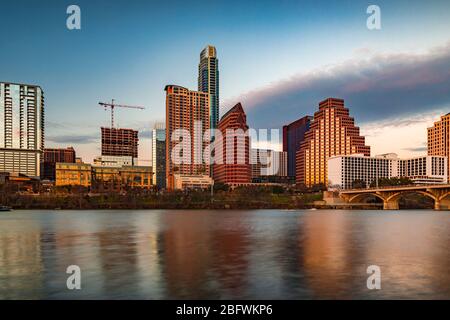 Downtown high-rises reflecting sunset golden hour light viewed across Lady Bird Lake or Town Lake on Colorado River in Austin, Texas, USA Stock Photo