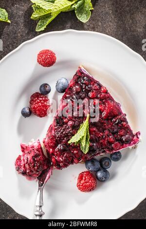 Sweet berry cake. Pie with blueberries and raspberries on plate. Top view. Stock Photo