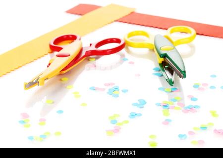 Colorful zigzag scissors with paper strips isolated on white Stock Photo
