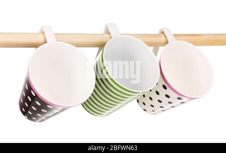 Nice cups hanging on stick isolated on white Stock Photo