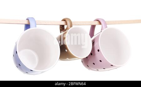Nice cups hanging on stick isolated on white Stock Photo