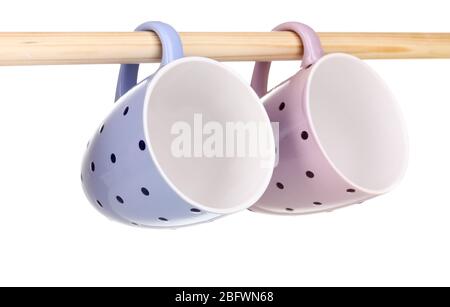 Nice cups hanging on stick isolated on white Stock Photo