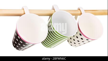 Nice cups hanging on stick isolated on white Stock Photo