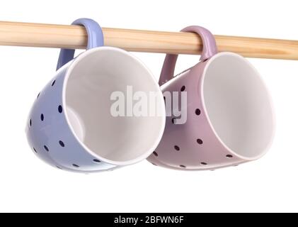 Nice cups hanging on stick isolated on white Stock Photo