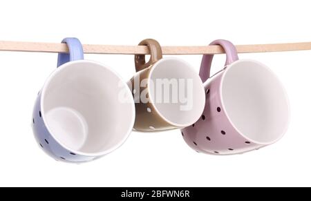 Nice cups hanging on stick isolated on white Stock Photo