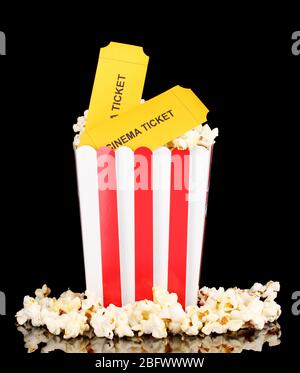 popcorn with cinema tickets isolated on black Stock Photo