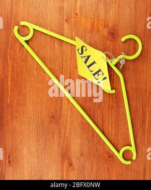 coat hanger with sale tag on wooden background Stock Photo