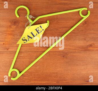 coat hanger with sale tag on wooden background Stock Photo