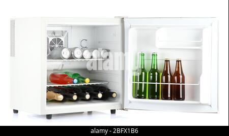 Mini fridge full of bottles of alcoholic beverages isolated on white Stock Photo