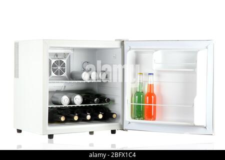 Mini fridge full of bottles of alcoholic beverages isolated on white Stock Photo