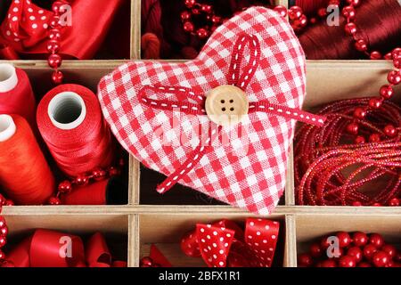 Red thread and material for handicrafts in box close-up Stock Photo