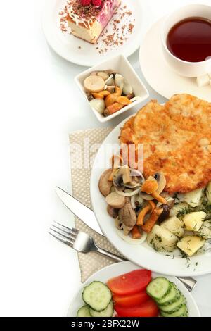 Roast chicken cutlet with boiled potatoes and mushrooms, cup of tea isolated on white Stock Photo
