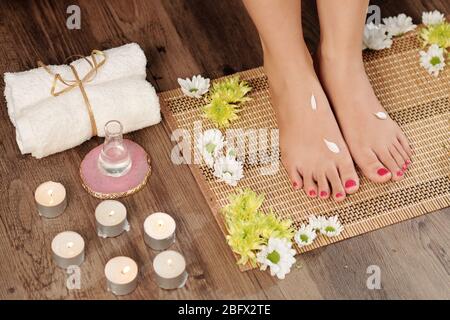 Beautiful feet of young woman after getting professional pedicure in beauty salon Stock Photo