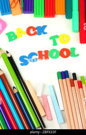 The words 'Back to School' composed of letters with various school supplies close-up isolated on white Stock Photo