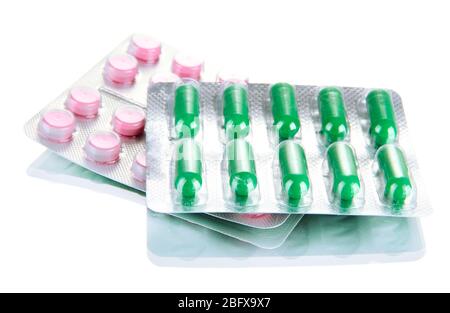 Capsules and pills packed in blisters, isolated on white Stock Photo