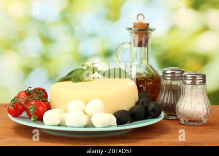 cheese mozzarella with vegetables in the plate on wooden table close-up Stock Photo