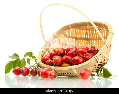 ripe hip roses with leaves in basket, isolated on white Stock Photo