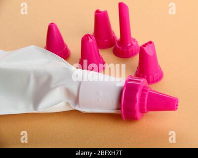 confectionery bag and replaceable nozzles, on orange background Stock Photo