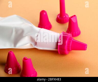 confectionery bag and replaceable nozzles, on orange background Stock Photo