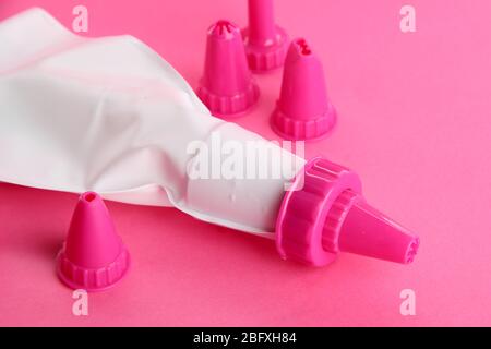 confectionery bag and replaceable nozzles, on pink background Stock Photo