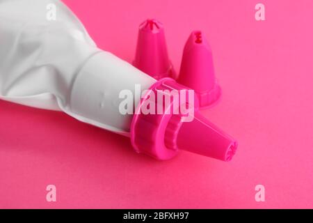 confectionery bag and replaceable nozzles, on pink background Stock Photo