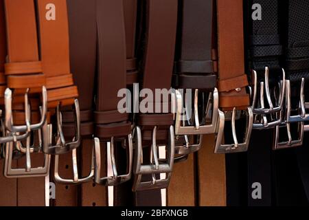 Leather men belts with buckles for sale. Stock Photo