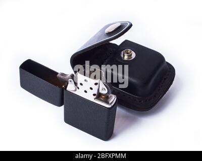 Metal lighter and leather case isolated on white. Stock Photo