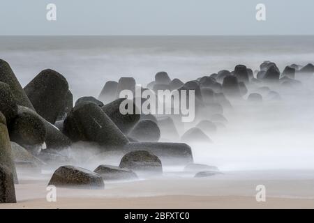 mystical viel on coastal rocks covered with ocean spray Stock Photo
