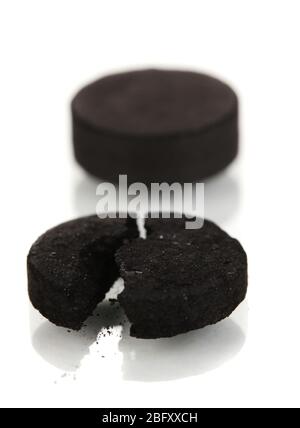 activated carbon in tablets isolated on white Stock Photo