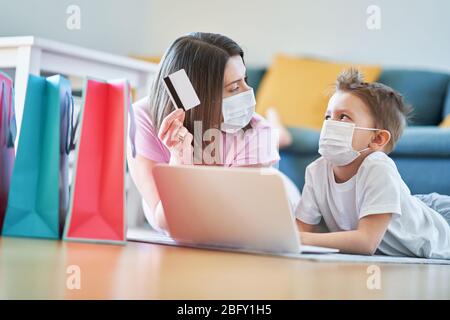 Mother and child shopping online during coronavirus pandemic Stock Photo