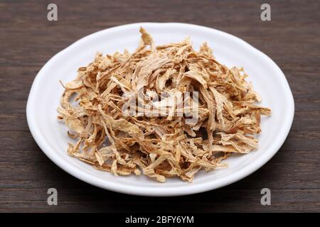 chinese medicine, dried plants in a plate on white background Stock Photo