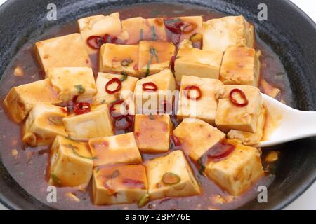 Close up of Chinese cuisine mapo doufu with spoon Stock Photo
