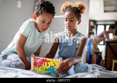 Children, education, plyaing happiness concept. Happy kids entertaining themselves at home Stock Photo