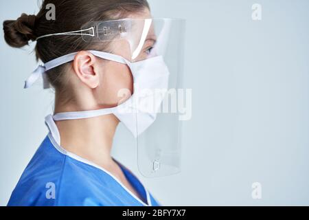 Portrait of female medical doctor wearing protective mask and face shield Stock Photo
