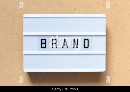White lightbox with word brand on wood background Stock Photo