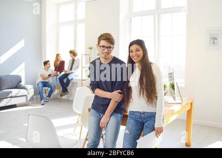 Teamwork. Students prepare a job analyze discuss business strategies at a table in the office. Stock Photo