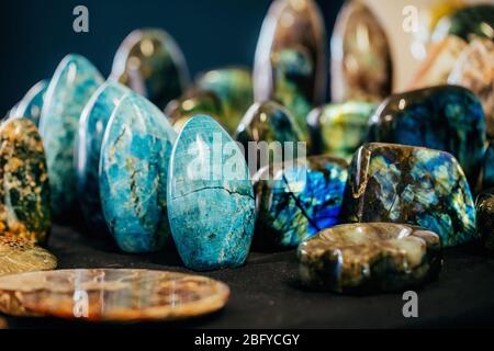 Various natural colorful different shape stones minerals gems on the display shelf. Stock Photo